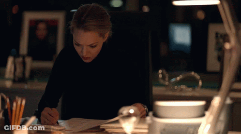Woman In Black Turtleneck Writing At Desk GIF