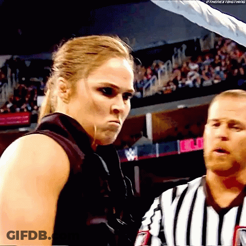Woman In Black Vest Next To Man In Striped Shirt GIF