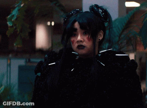 Woman In Black Wig And Black Sweater GIF