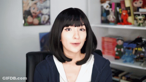 Woman In Black Wig And Blue Hoodie Looking At Camera GIF