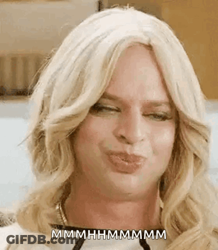 Woman In Blonde Wig Blowing Kiss GIF