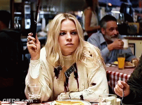 Woman In Bloody Sweater Holding Knife GIF