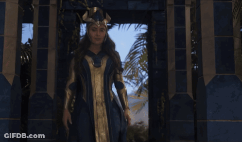 Woman In Blue And Gold Costume By Building GIF