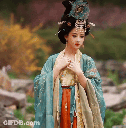 Woman In Blue And Gold Dress With Flower On Head GIF