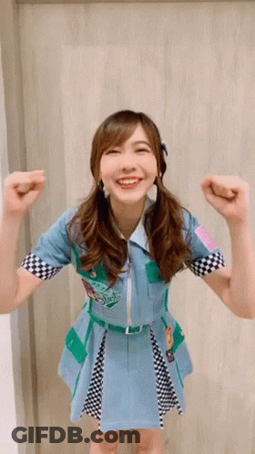 Woman In Blue And Green Dress Smiling GIF