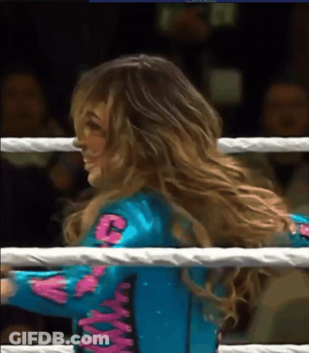 Woman In Blue And Pink Outfit With Letter C In Boxing Ring GIF