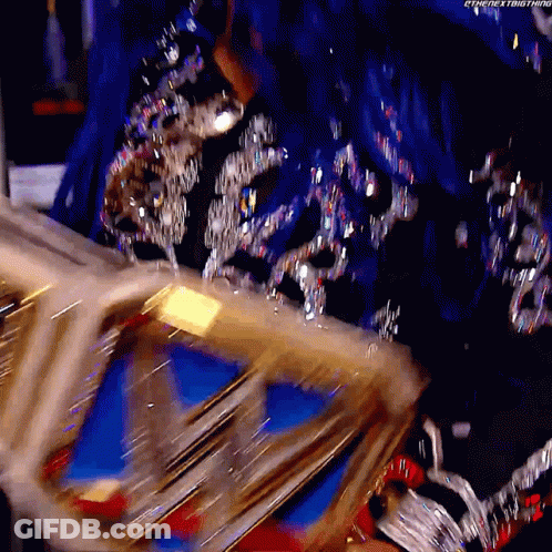 Woman In Blue And Silver Dress Holding Gold Crown GIF