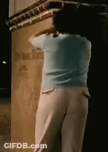 Woman In Blue And White By Building Night GIF