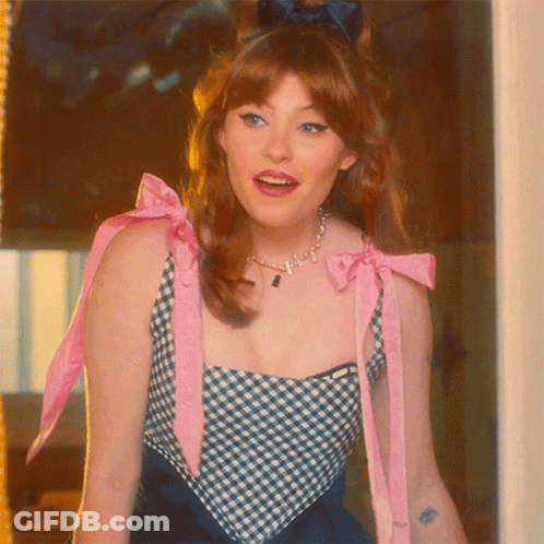 Woman In Blue And White Checkered Top With Pink Bow GIF