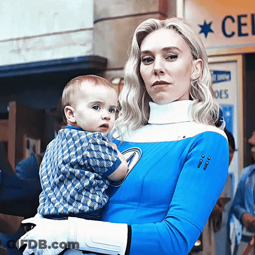 Woman In Blue And White Costume Holding Baby GIF
