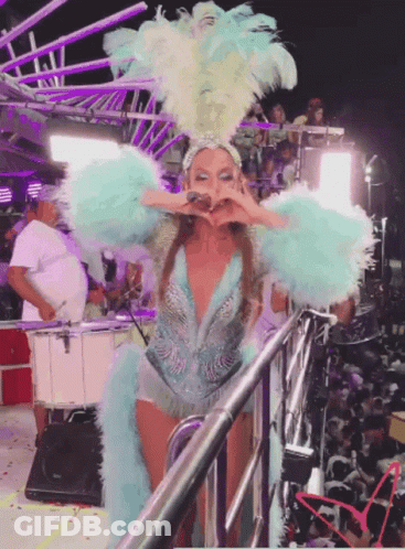 Woman In Blue And White Feathered Costume On Stage GIF