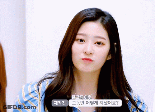 Woman In Blue And White Striped Shirt Looks At Camera GIF