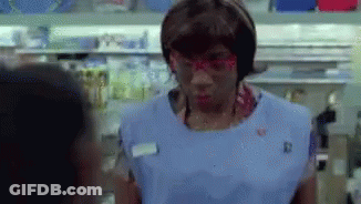Woman In Blue Apron And Red Glasses Talking To Man GIF
