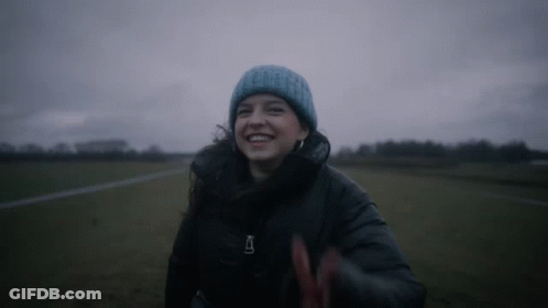 Woman In Blue Beanie And Black Jacket With Letter A GIF
