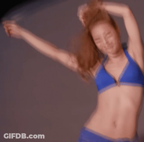 Woman In Blue Bikini Dancing With Arms Outstretched GIF