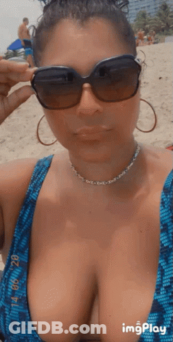Woman In Blue Bikini Taking Beach Selfie GIF