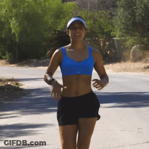 Woman In Blue Bra And Black Shorts Running On Road GIF