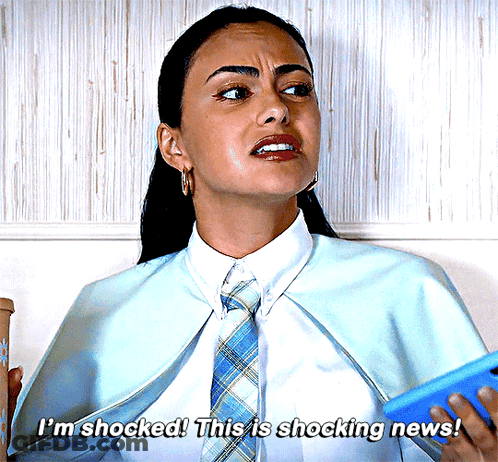 Woman In Blue Cape And Tie Says Shocked GIF