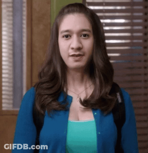 Woman In Blue Cardigan And Green Tank Top GIF