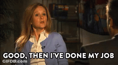 Woman In Blue Cardigan Talking To Man In Suit GIF