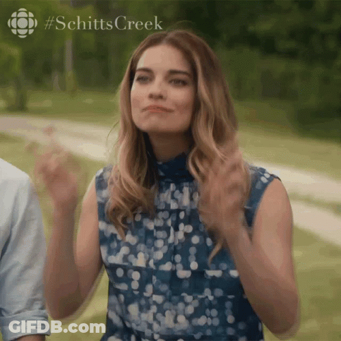 Woman In Blue Clapping Schitt's Creek Logo GIF