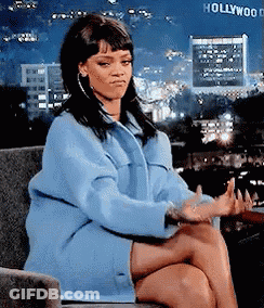 Woman In Blue Coat In Front Of Hollywood Sign GIF