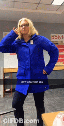 Woman In Blue Coat In Front Of Poly Sign GIF