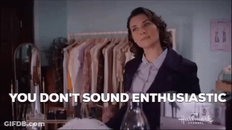 Woman In Blue Coat Sitting In Front Of Hollywood Sign GIF