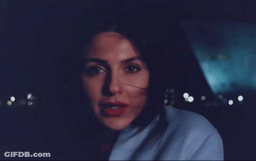 Woman In Blue Coat Smiling At Camera GIF