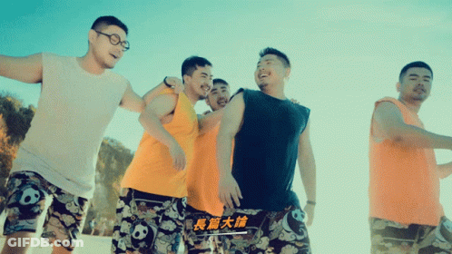 Woman In Blue Crop Top And Black Shorts Smiling And Waving GIF