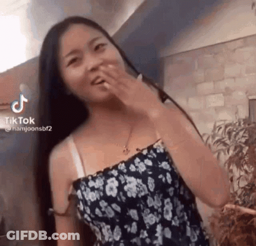Woman In Blue Dress And Flip Flops Sitting In Chair GIF