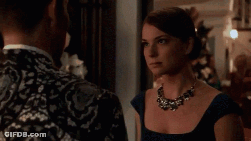 Woman In Blue Dress And Necklace Looking At Man GIF