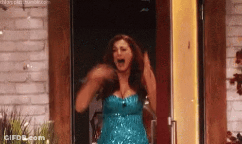 Woman In Blue Dress Arms Up In Doorway GIF
