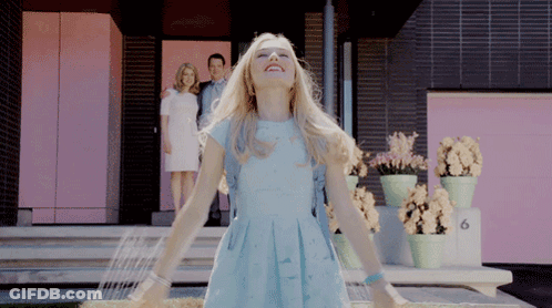 Woman In Blue Dress At Pink Building Number 6 GIF