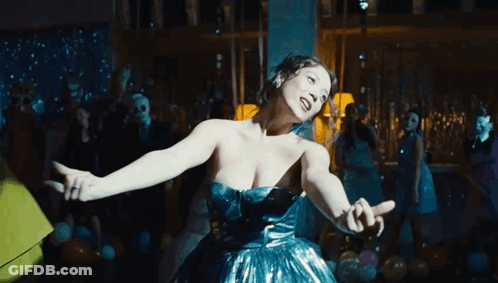 Woman In Blue Dress Dancing In Crowded Room GIF