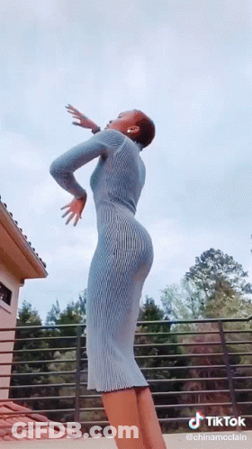 Woman In Blue Dress Dancing On Balcony TikTok GIF