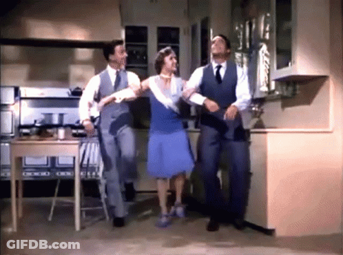 Woman In Blue Dress Dancing With Two Men In Suits GIF