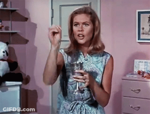 Woman In Blue Dress Holding Glass GIF