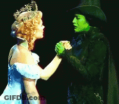 Woman In Blue Dress Holding Hands With Green Woman GIF