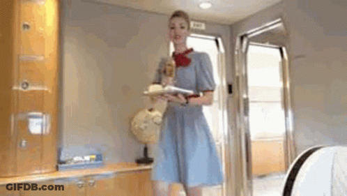 Woman In Blue Dress Holding Tray Of Food GIF