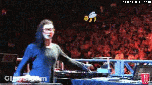 Woman In Blue Dress In Front Of Crowd With Bee GIF