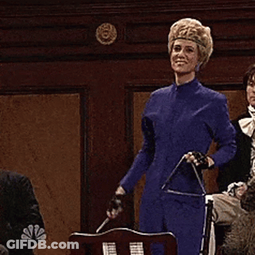 Woman In Blue Dress In Front Of NBC Logo GIF