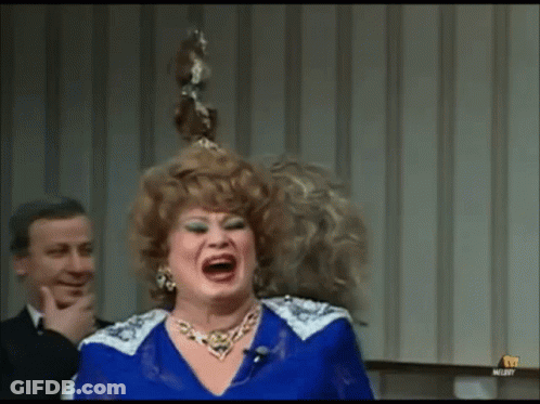 Woman In Blue Dress Laughing While Man Looks On GIF