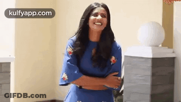 Woman In Blue Dress Laughing With Arms Crossed GIF