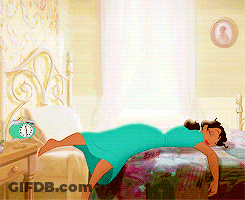 Woman In Blue Dress Laying On Bed With Alarm Clock GIF
