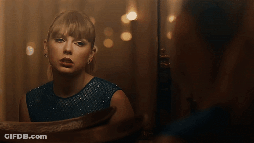 Woman In Blue Dress Looking In Mirror GIF