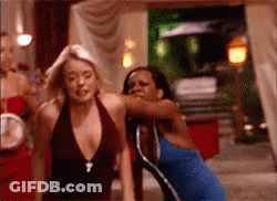 Woman In Blue Dress Next To Woman In Brown Top GIF