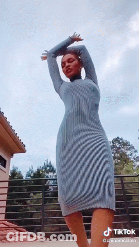 Woman In Blue Dress On Balcony GIF