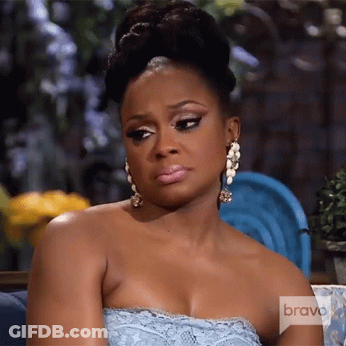 Woman In Blue Dress On Couch With Bravo GIF