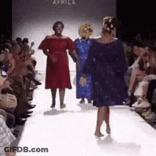 Woman In Blue Dress On Runway At Africa Fashion Show GIF